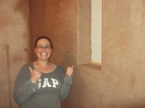 woman showing the work she has completed on her plastering course in stoke-on-trent