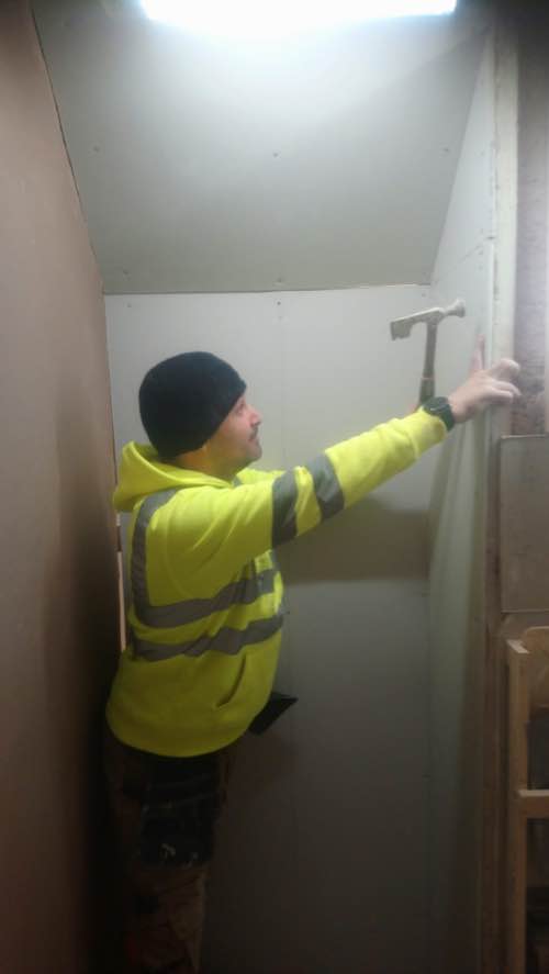 person fixing plasterboards