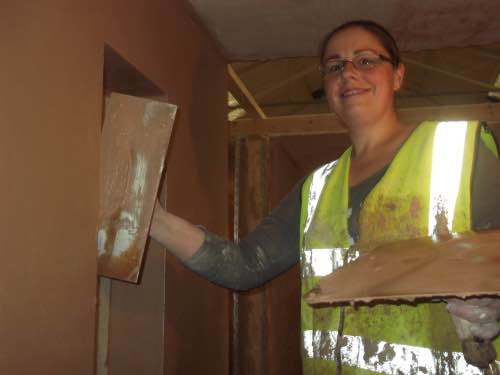 lady plastering window reveals during her plastering training