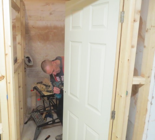 person drilling door on a carpentry course