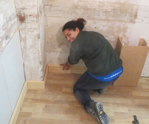 lady on carpentry course fitting skirting