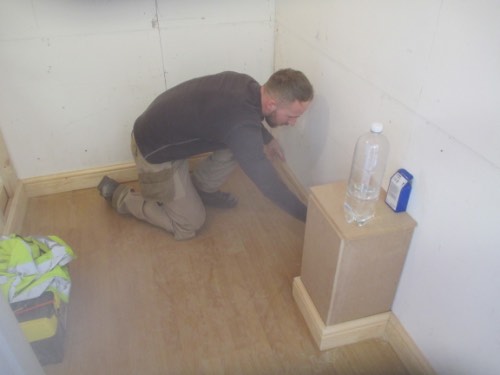 person fitting skirting boards