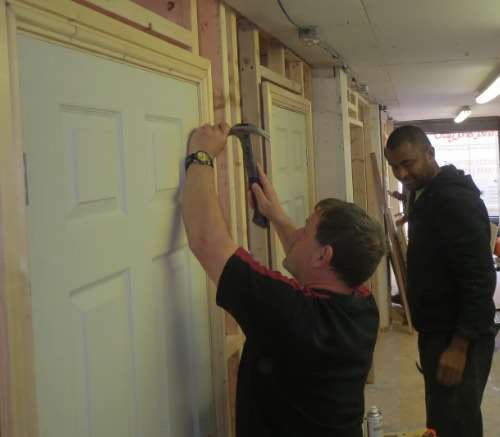 person from liverpool fitting architrave on carpentry course