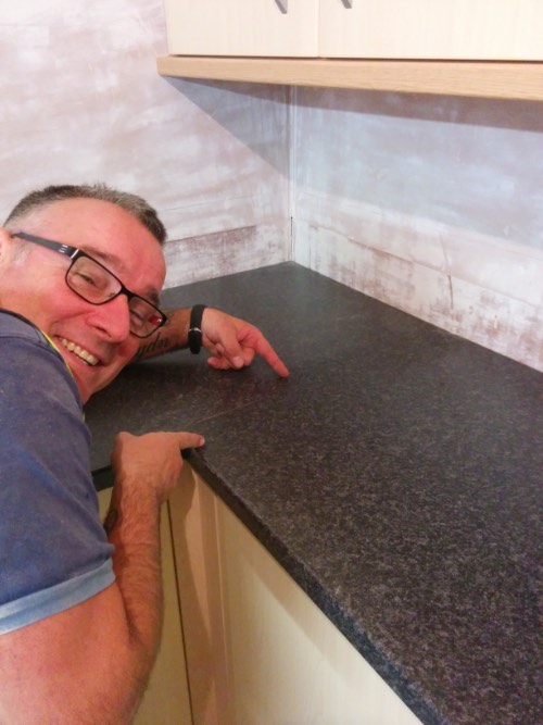 person showing the invisible join on two kitchen worktops