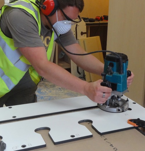 person using a router to cut worktops