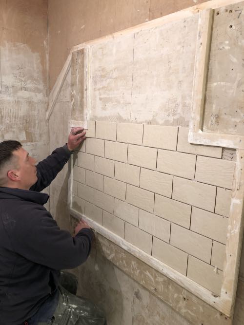 person completing tiling task
