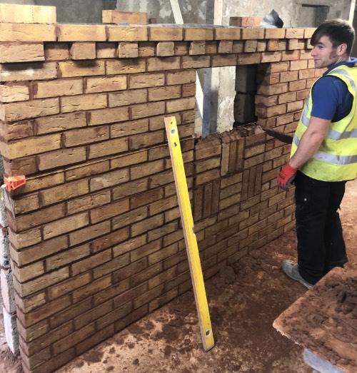 person building a decorative panel on bricklaying course